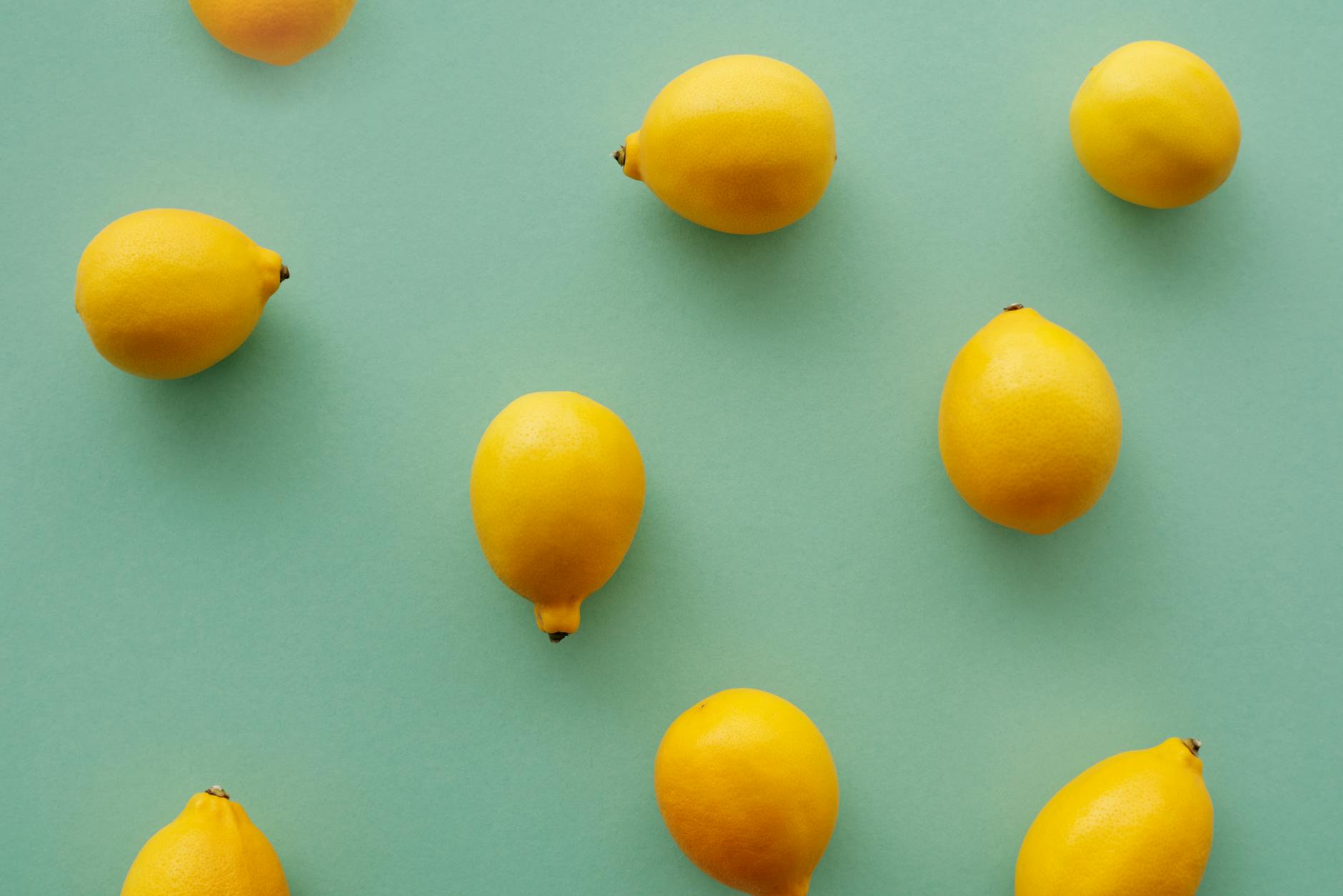 A woman holding a fresh lemon, representing the gentle, patient approach to building arousal
