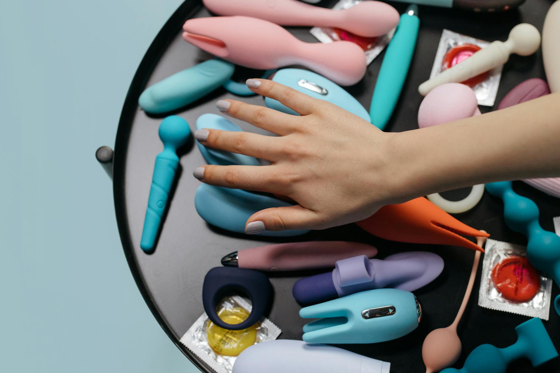 A collection of colorful vibrators arranged on a neutral surface, representing different options for restoring sensation.