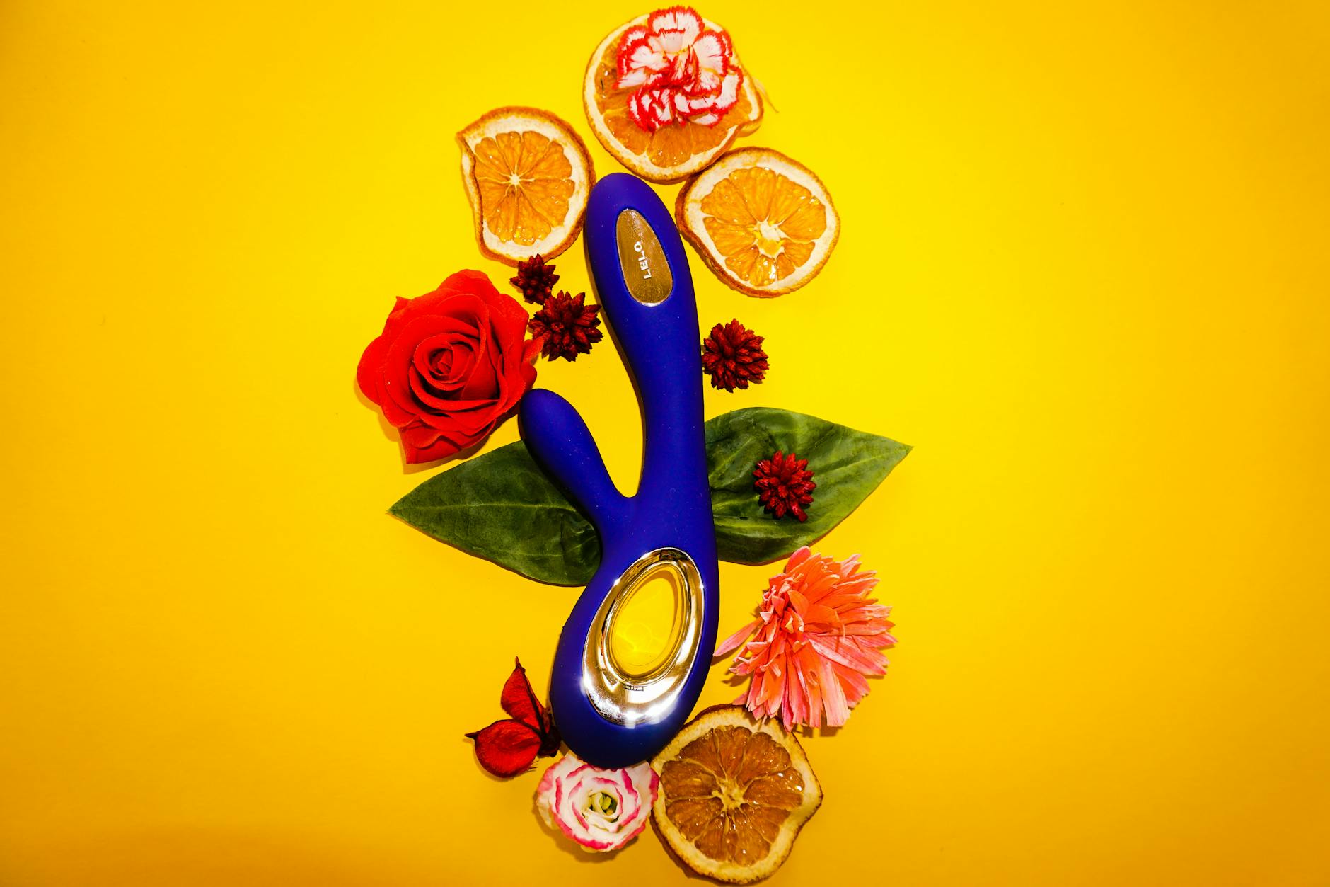 Colorful lemon and other clitoral vibrators on a bright yellow background, showcasing various designs